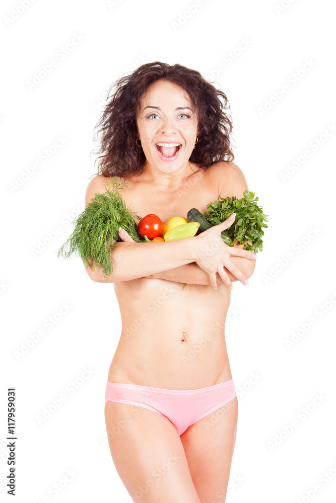 Beautiful model holding a vegetables and salad. She shows the abdomen and waist. The concept of a healthy diet and lifestyle. Weight Loss. Beautiful model holding a vegetables and salad. She shows the abdomen and waist. The concept of a healthy diet and lifestyle. Weight Loss.