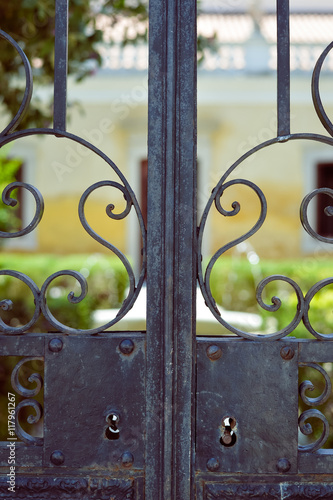 Closeup detailt of beautiful old ornate metal door outdoors background photo