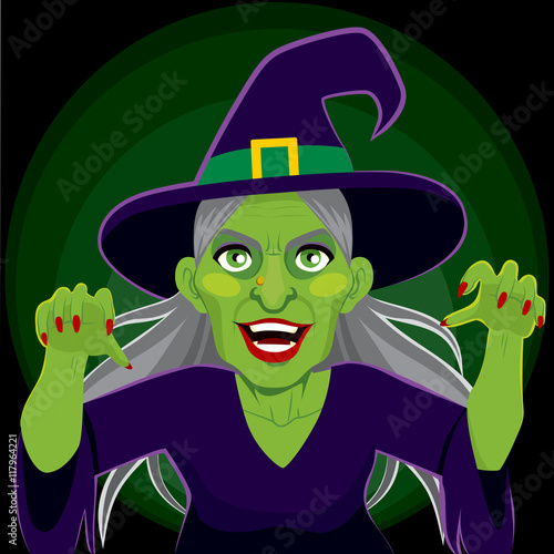 Old evil scary green skin witch with menacing arms up expression on dark background