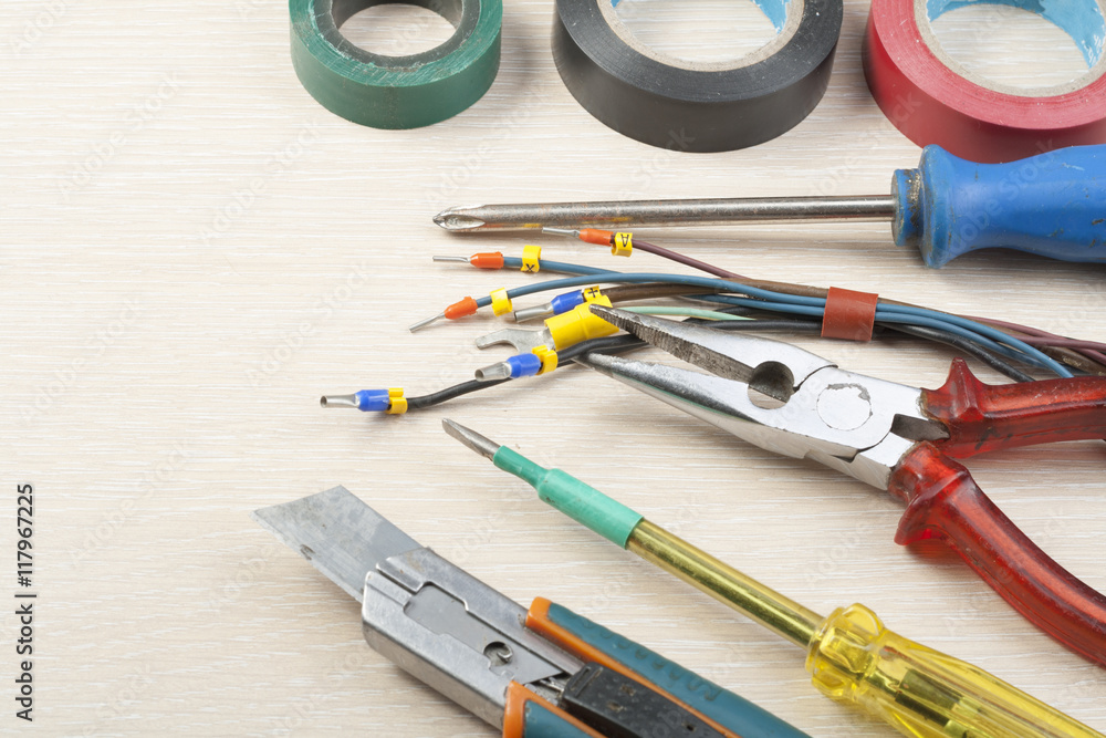Set of electrical tool on wooden background. Accessories for engineering work, energy concept. Set of electrical tool on wooden background. Accessories for engineering work, energy concept.