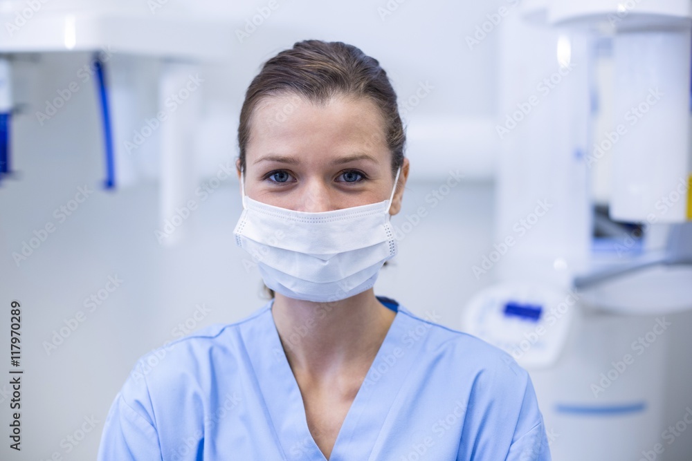 Dental assistant wearing surgical mask in dental clinic Dental assistant wearing surgical mask in dental clinic