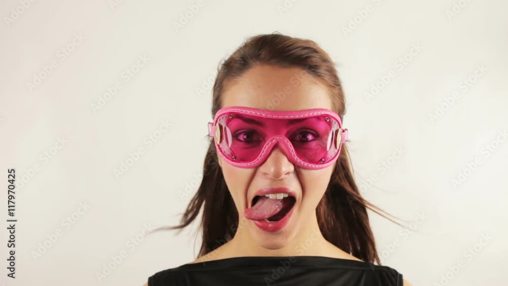 woman wearing retro goggles making faces woman wearing retro goggles making faces