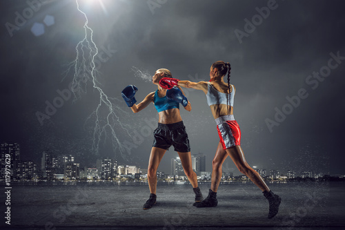 Fototapeta Naklejka Na Ścianę i Meble -  Girls boxing outdoor . Mixed media