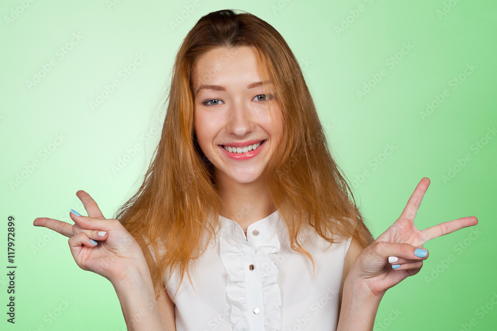 Closeup portrait of happy, excited successful young woman giving peace Closeup portrait of happy, excited successful young woman giving peace