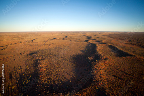 Aerial View of Desert Outback Australia at Sunset (near Ayres Rock - Uluru) photo