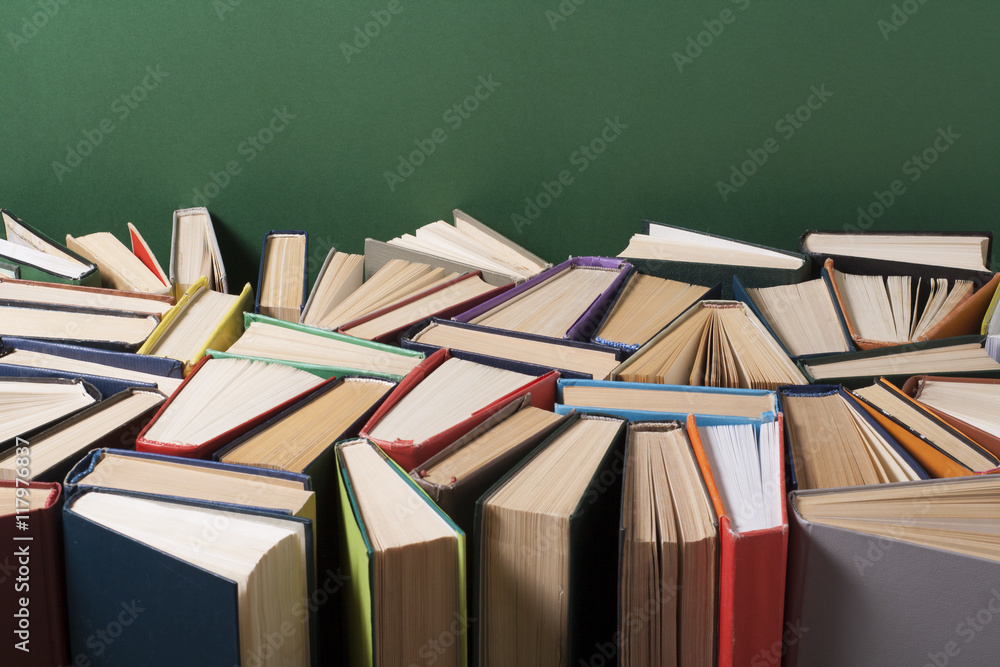 Obraz premium Open book, hardback books on wooden table. Education background. Back to school. Copy space for text.