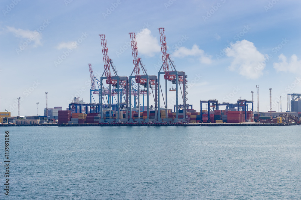 Several container crane on the berth of sea cargo port