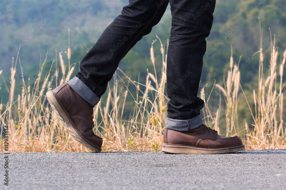 Fototapeta premium a man walking on the road