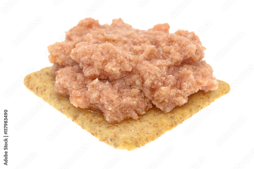 Deviled ham a whole wheat cracker on a white background. Deviled ham a whole wheat cracker on a white background.