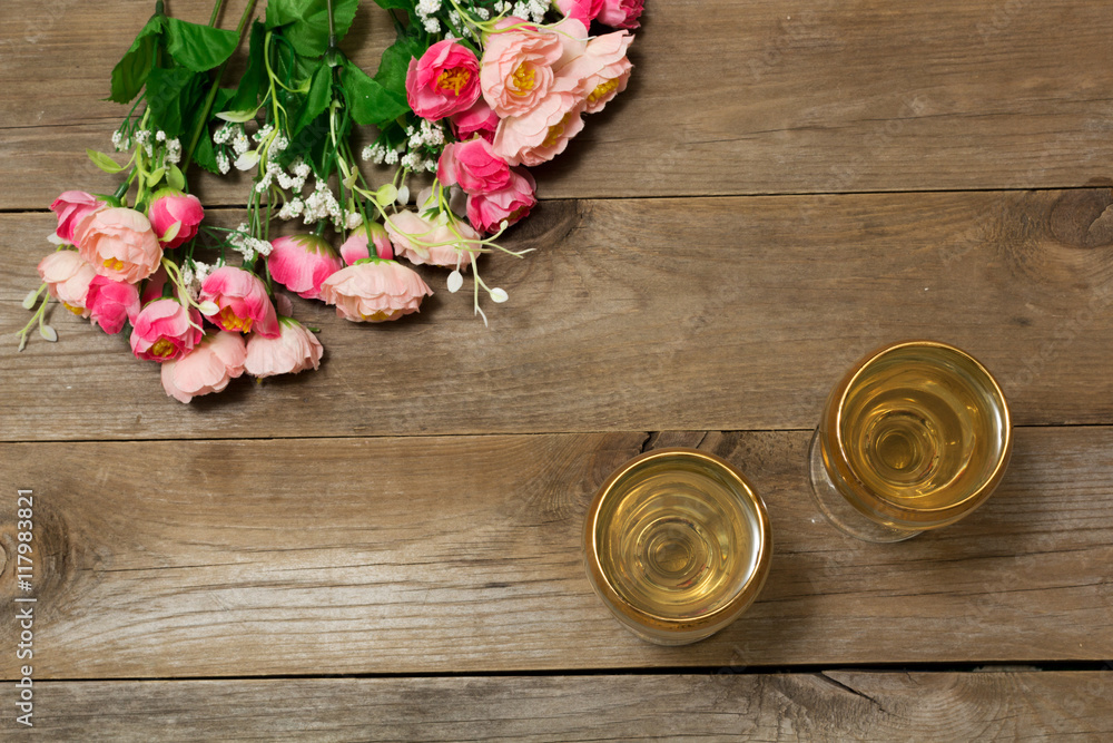 Two glasses of white wine and flowers Two glasses of white wine and flowers