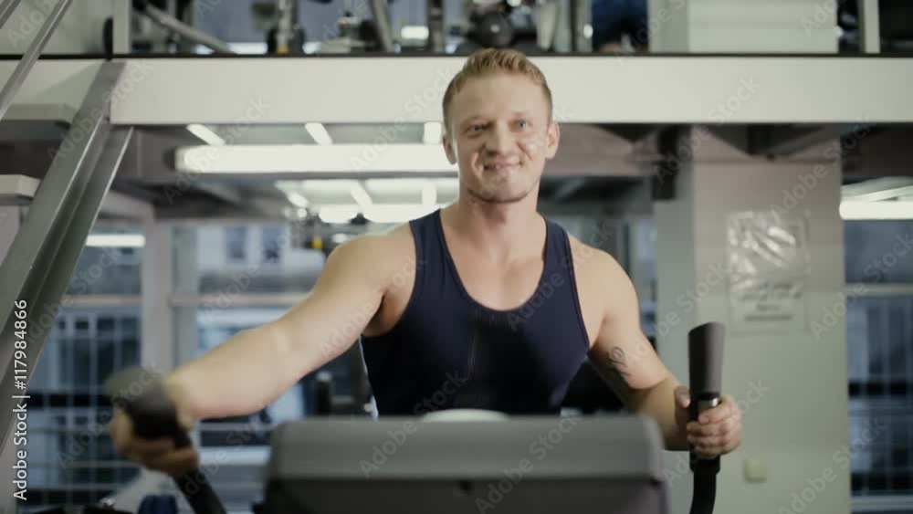 Sportsman doing cardio exercise in gym Sportsman doing cardio exercise in gym