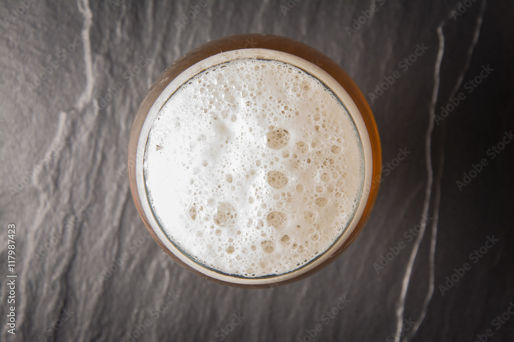 Glass beer on stone background with copy space. wallpaper Glass beer on stone background with copy space. wallpaper