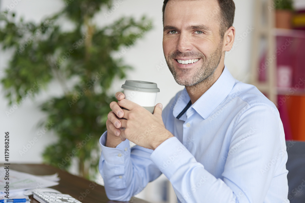 Man with coffee next to the computer Man with coffee next to the computer