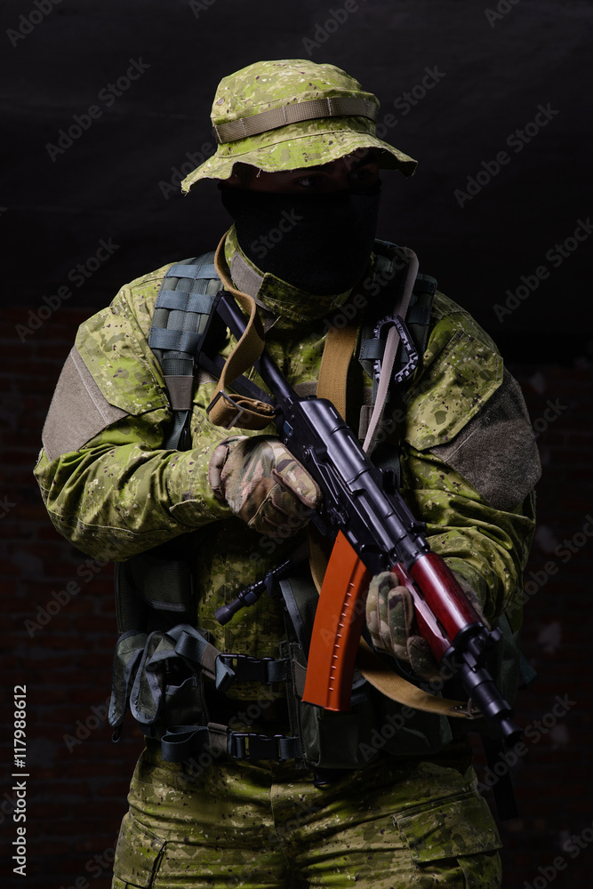 Fototapeta premium Soldier with gun/Special forces soldier with assault rifle on dark background