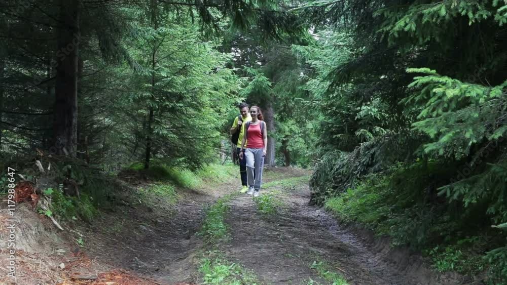 Couple Backpackers hiking on the path in mountains Couple Backpackers hiking on the path in mountains