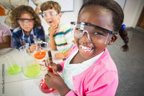 Kids doing a chemical experiment in laboratory photo
