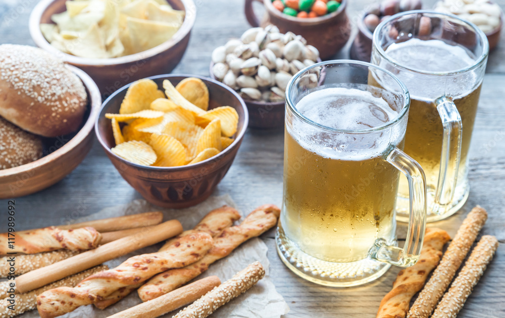 Two glasses of beer with appetizers Two glasses of beer with appetizers