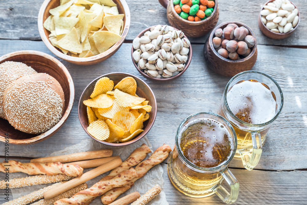 Two glasses of beer with appetizers