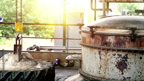 Steam distillation machine extracts the essential lavender oil against sunset sky.