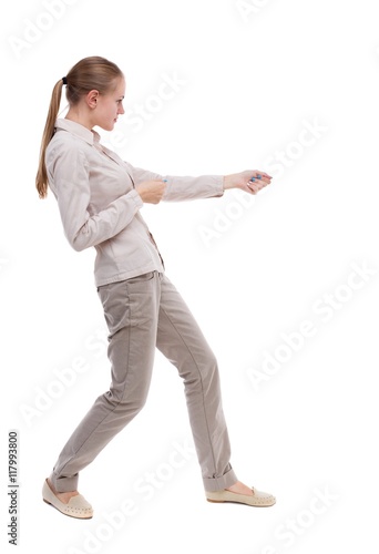 back view of standing girl pulling a rope from the top or cling to something. girl watching. Rear view people collection. backside view of person. Isolated over white background. Girl with long