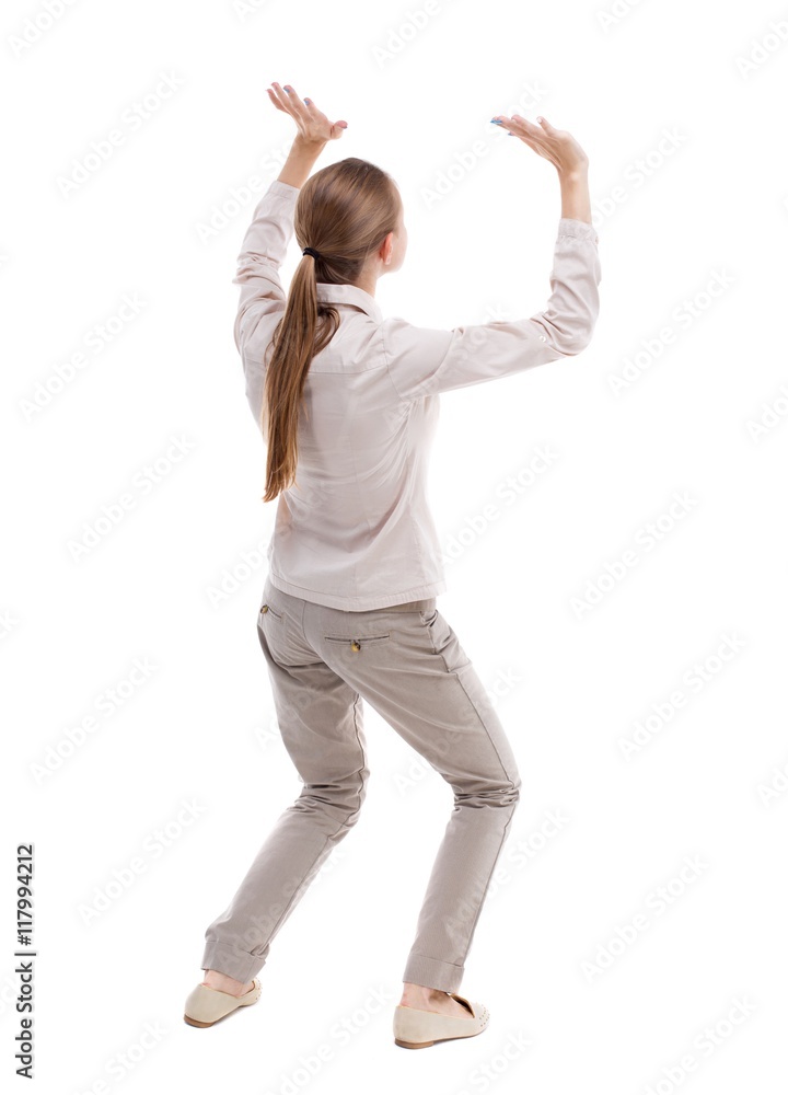 back view of woman protects hands from what is falling from above. woMan holding a heavy load Rear view people collection. backside view of person. Isolated over white background. Girl with long back view of woman protects hands from what is falling from above. woMan holding a heavy load Rear view people collection. backside view of person. Isolated over white background. Girl with long