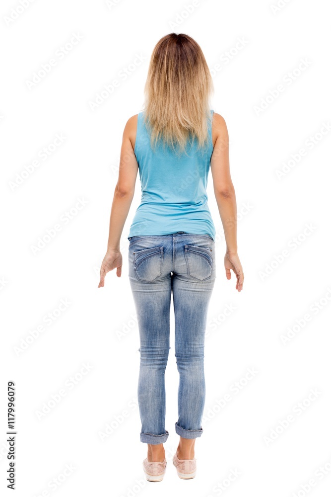 back view of standing young beautiful woman. girl watching. Rear view people collection. backside view of person. Isolated over white background. The girl in jeans and a blue t-shirt standing back view of standing young beautiful woman. girl watching. Rear view people collection. backside view of person. Isolated over white background. The girl in jeans and a blue t-shirt standing