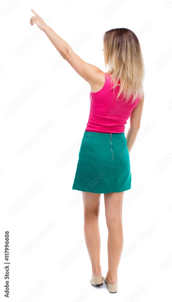 Back view of pointing woman. beautiful girl. Rear view people collection. backside view of person. Isolated over white background. Girl in a green skirt shows the right hand to the sky. Back view of pointing woman. beautiful girl. Rear view people collection. backside view of person. Isolated over white background. Girl in a green skirt shows the right hand to the sky.