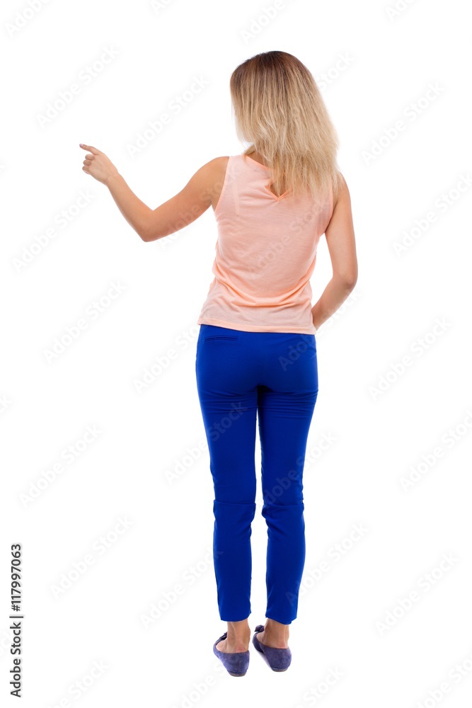 Back view of pointing woman. beautiful girl. Rear view people collection. backside view of person. Isolated over white background. blonde in blue trousers is showing the right hand side. Back view of pointing woman. beautiful girl. Rear view people collection. backside view of person. Isolated over white background. blonde in blue trousers is showing the right hand side.