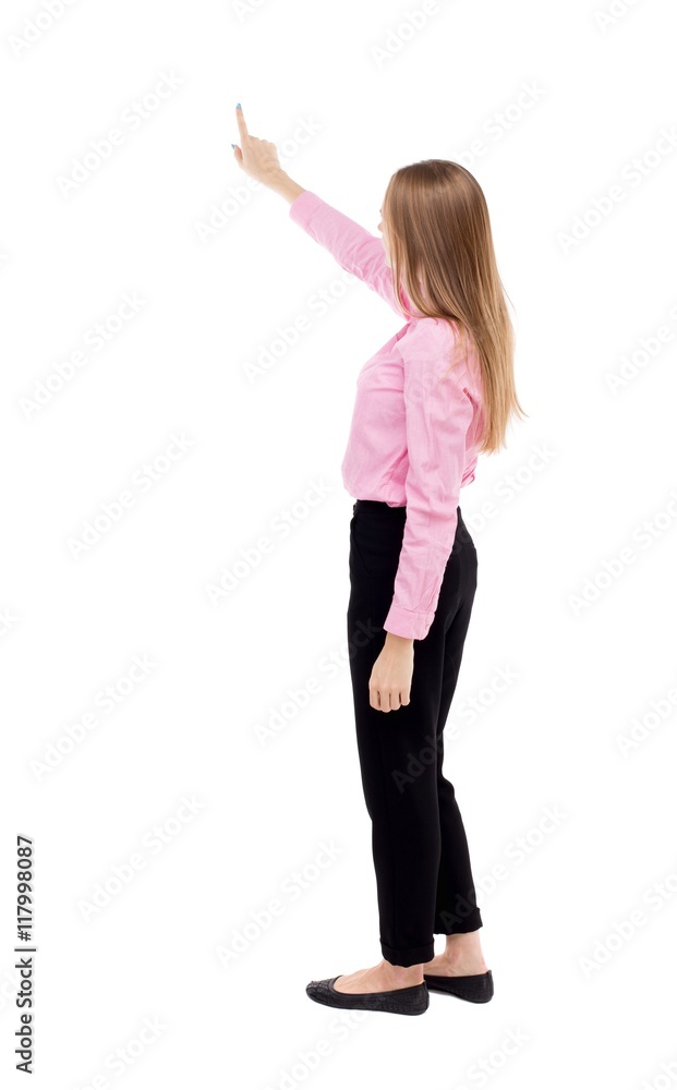 Back view of pointing woman. beautiful girl. Rear view people collection. backside view of person. Isolated over white background. Long-haired girl in a red shirt is standing sideways. Back view of pointing woman. beautiful girl. Rear view people collection. backside view of person. Isolated over white background. Long-haired girl in a red shirt is standing sideways.
