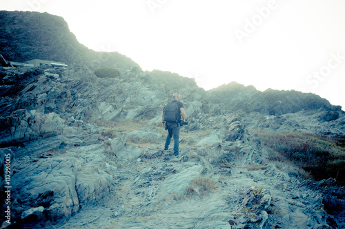 man walking on rocks, summer holidays