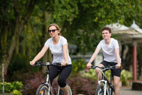 Healthy lifestyle - people riding bicycles in city park 