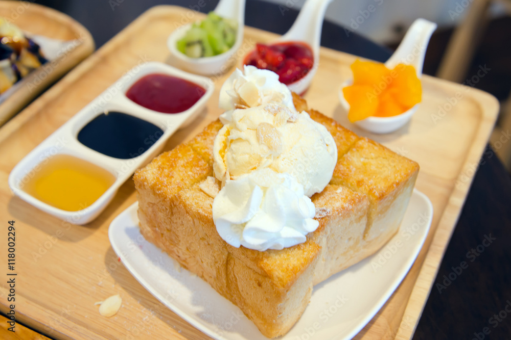 Closeup of honey toast with vanilla ice-cream, sauces and fruits Closeup of honey toast with vanilla ice-cream, sauces and fruits