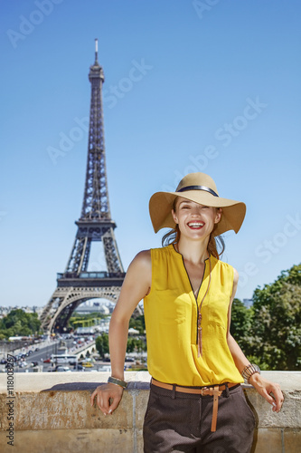 happy woman in bright blouse in front of Eiffel tower in Paris © Alliance