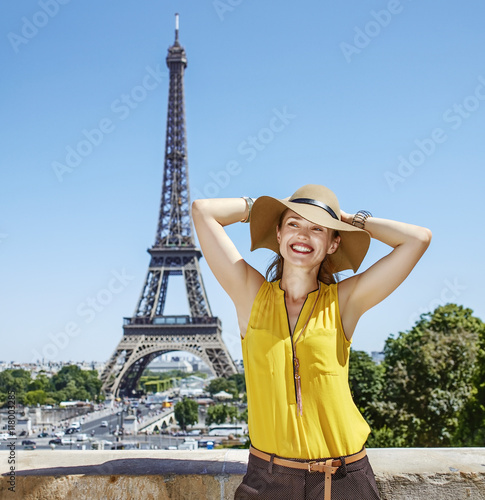 relaxed woman in bright blouse in front of Eiffel tower in Paris © Alliance