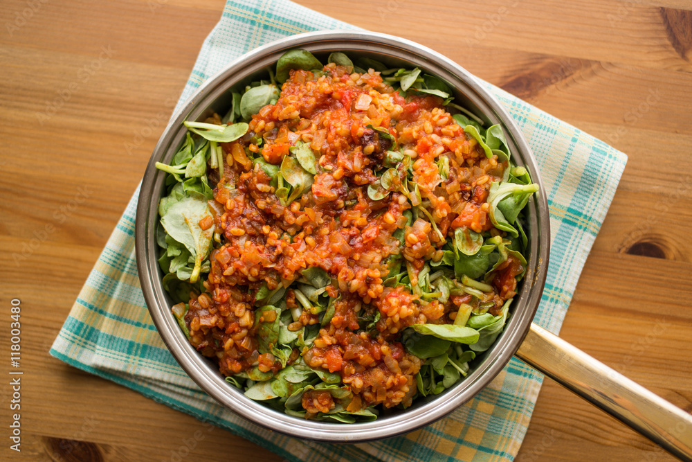 Purslane food with tomato sauce in a pan on a wicker. Purslane food with tomato sauce in a pan on a wicker.