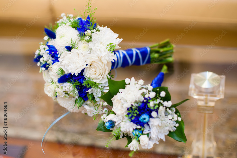 Blue and white wedding bouquet of roses on glass table