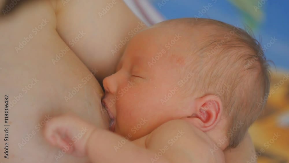 Newborn baby breastfeeding indoors Newborn baby breastfeeding indoors