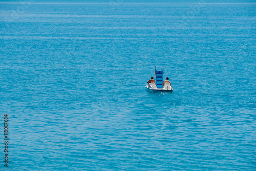 Couple riding pedal boat on a lake