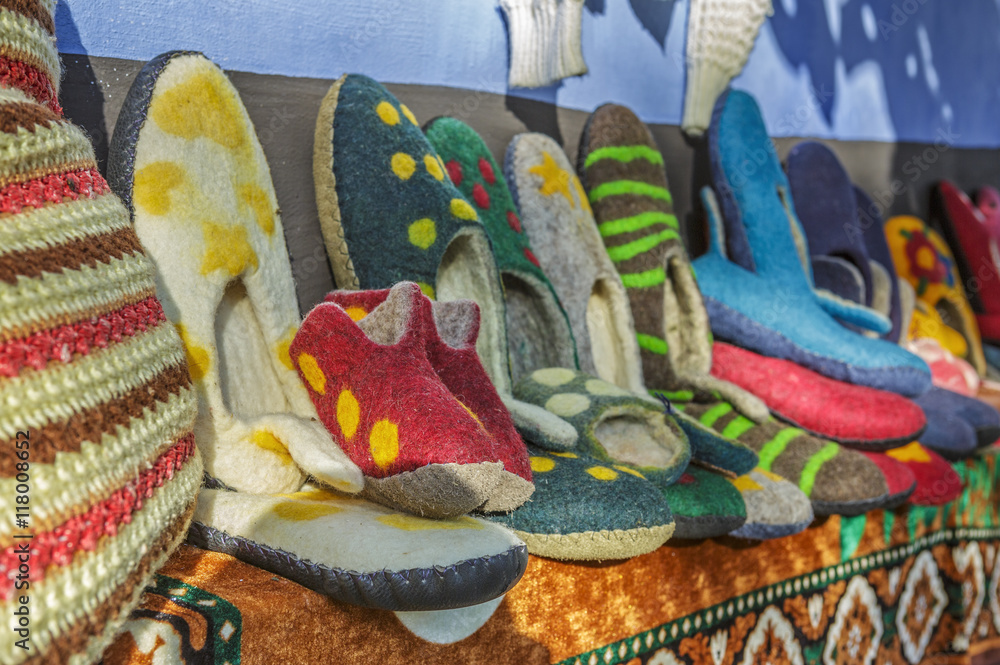 Colorful handmade wool and felt slippers exhibited at a traditional fair in Transylvanian village of Viscri, Romania.