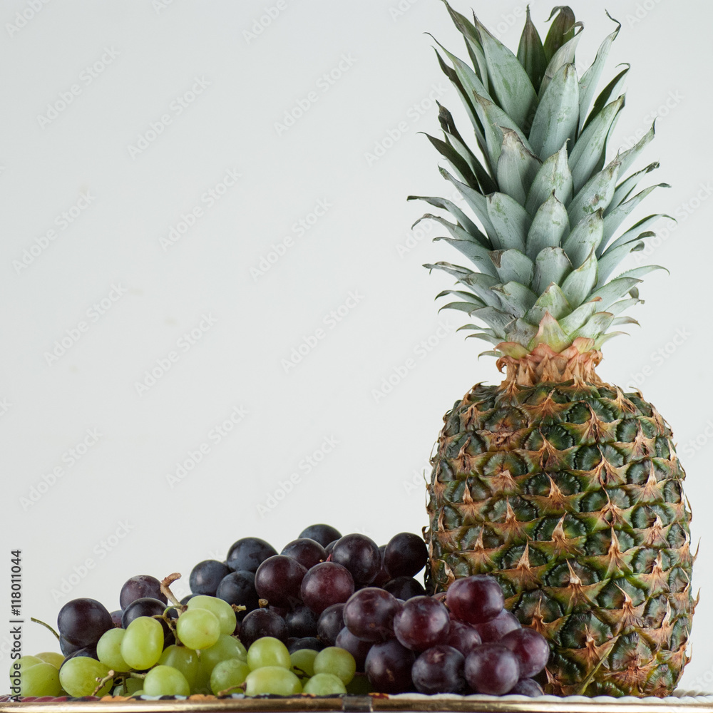 Ananas and green, red grape isolated on white Ananas and green, red grape isolated on white