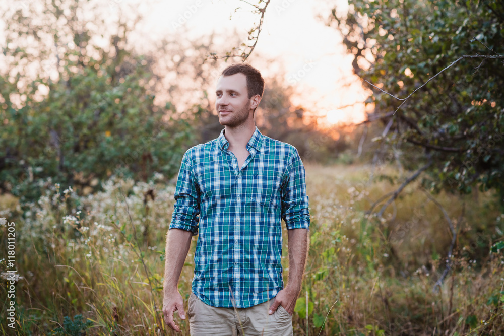 Portrait of a Man in plaid shirt on nature