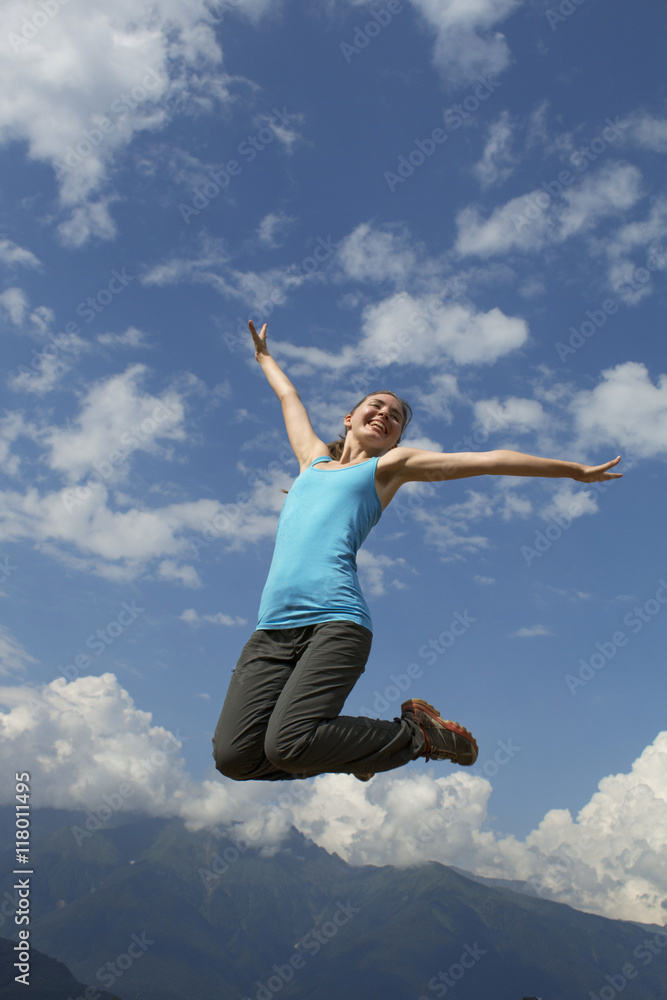 young happiness woman is jumping against blue sky. summer sunny day young happiness woman is jumping against blue sky. summer sunny day