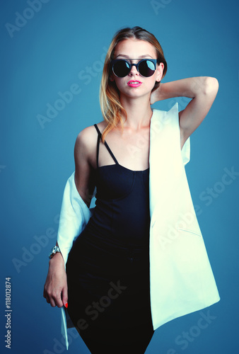 Surprised young woman in glasses over gray background