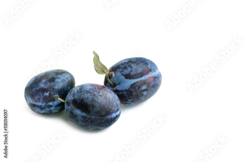 Three plums on white background