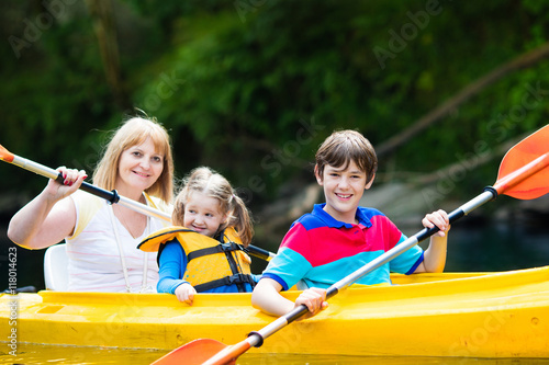 Family enjoying kayak ride on a river © famveldman