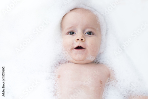 Toddler showing face just above water surface.