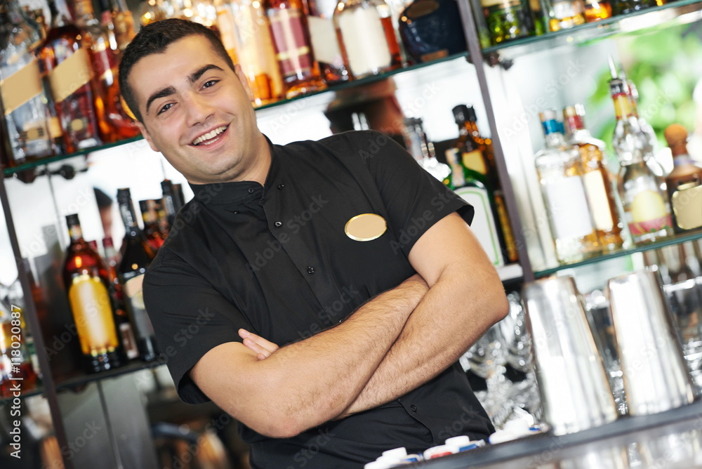 Barman worker standing at bartender desk Barman worker standing at bartender desk