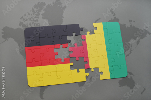 puzzle with the national flag of germany and guinea on a world map background.