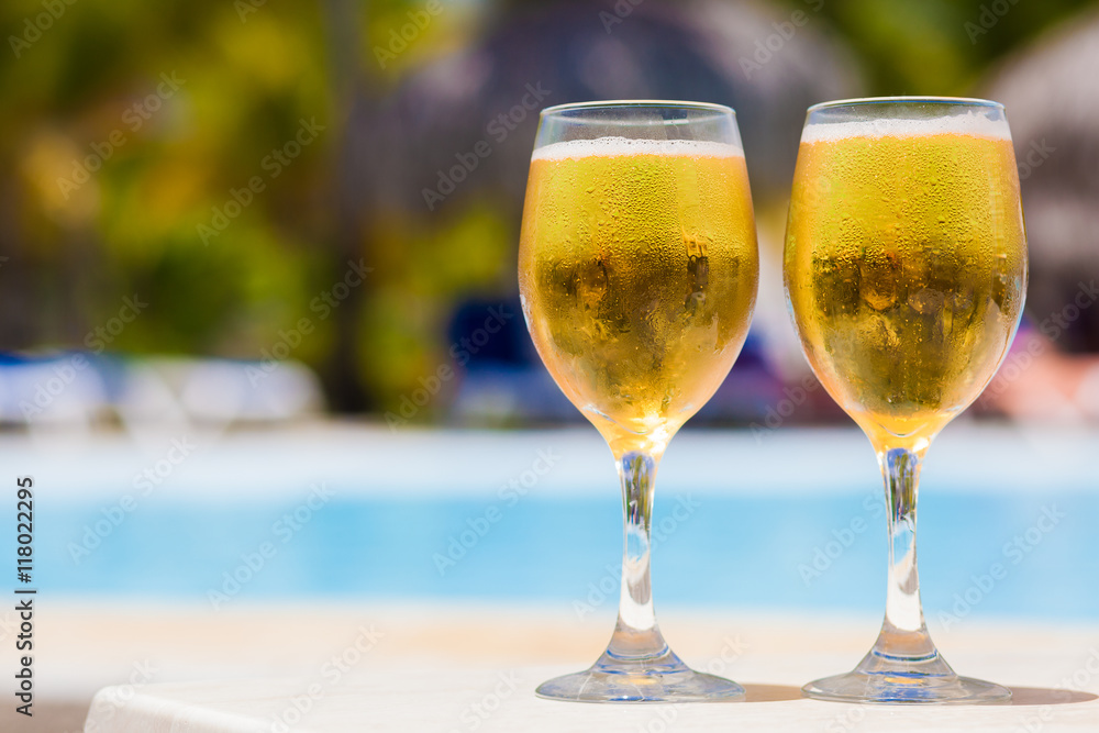 Wet glassses of beer by the pool Wet glassses of beer by the pool