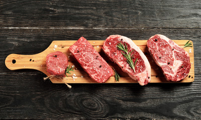 Fototapete Steakhouse Frische Black Angus Steaks Holzbrett  © davidchukalexey